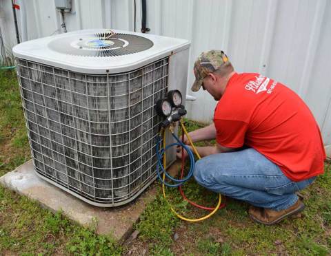 Hillenburg skilled technician repairing one of our valued customer's air conditioners